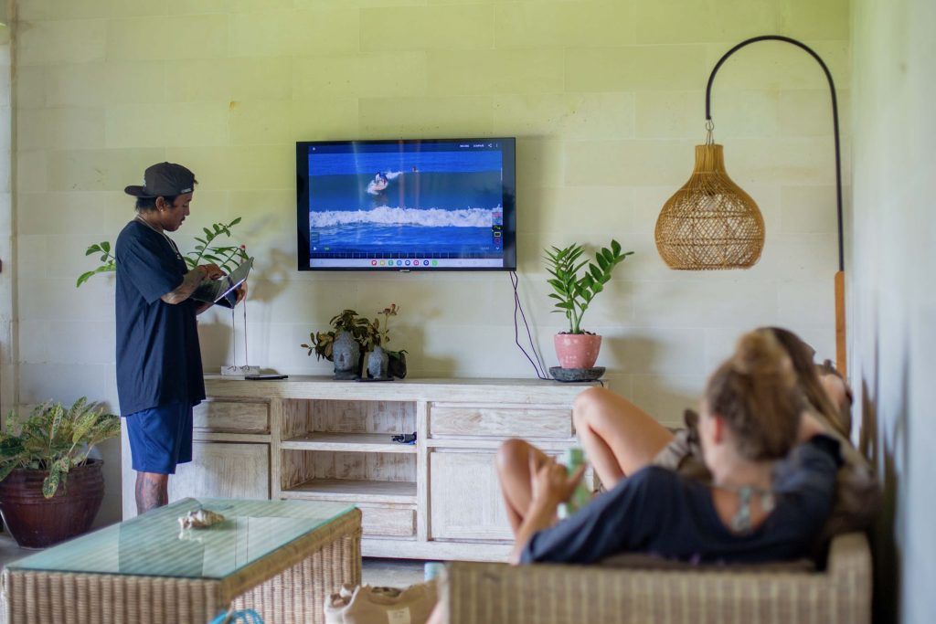 Small group video analysis session at a surf camp Bali with video analysis